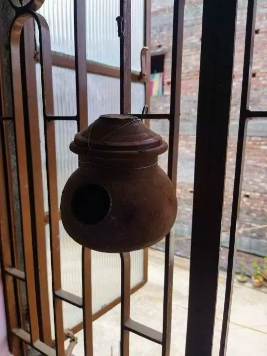 handing clay birdhouse for sale